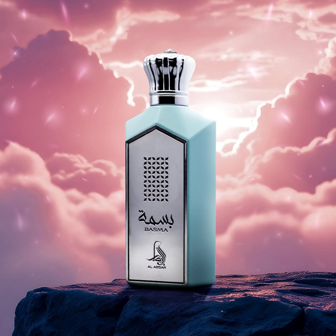 Perfume bottle labeled 'Basma' against a mystical sky with clouds