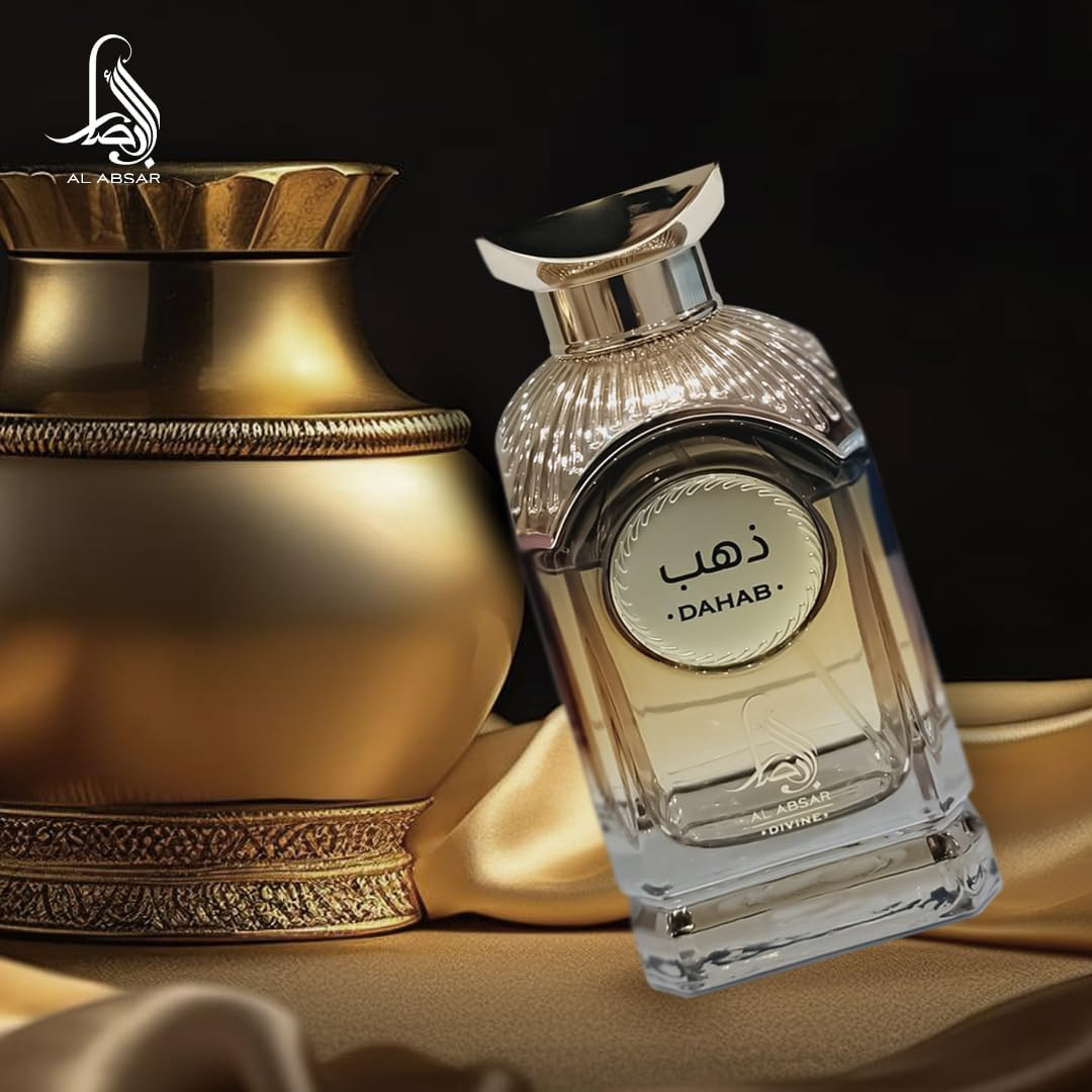 Perfume bottle labeled 'Dahab' next to a gold decorative item on a dark background