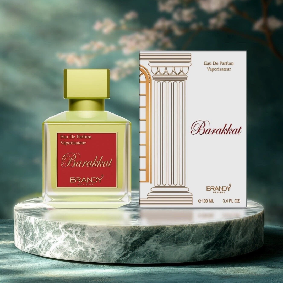 Barakkat Brandy perfume bottle and packaging on a marble platform with a blurred floral background