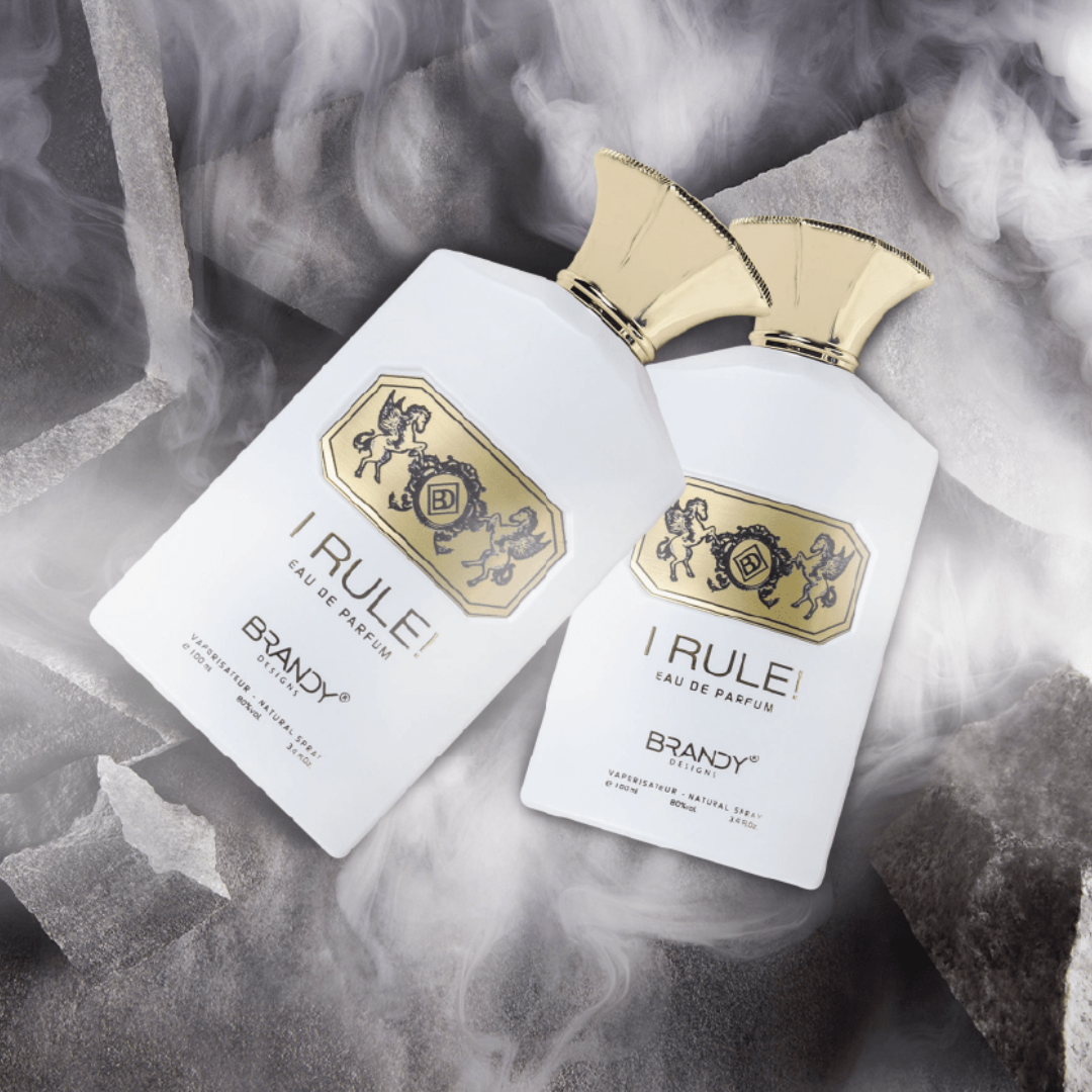 Two bottles of 'I Rule' Brandy perfume with gold accents on a smoky background.
