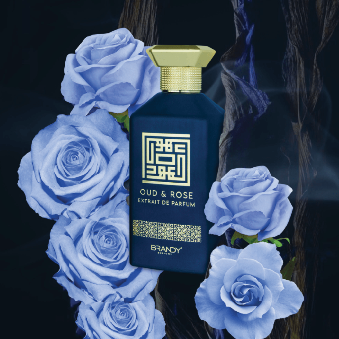 Perfume bottle labeled 'Oud & Rose' surrounded by blue roses on a dark background
