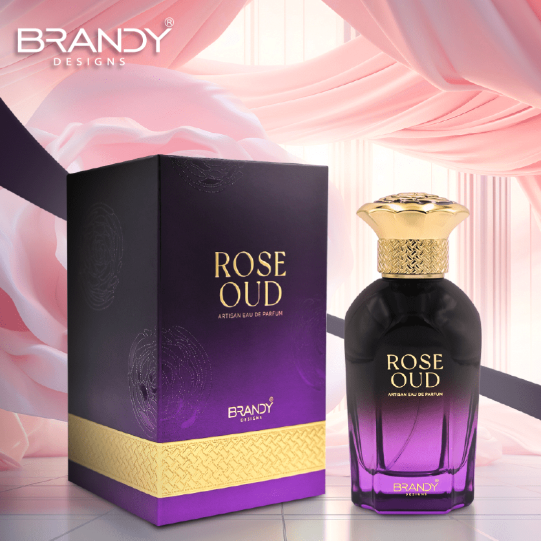 Rose Oud perfume bottle and packaging with 'Brandy Designs' branding on a pink floral background.
